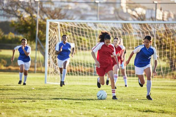 Young girls playing football on a community pitch